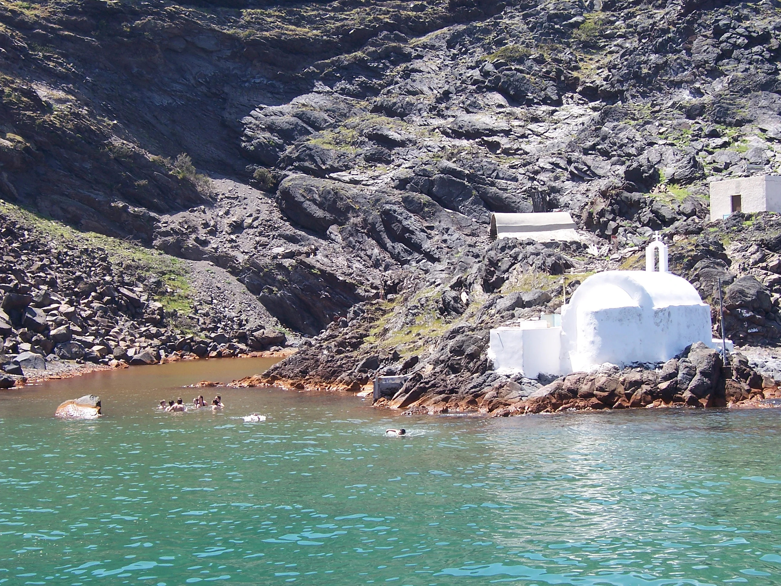 Visitors swimming in the hot-spring cove at Palea Kameni, Santorini